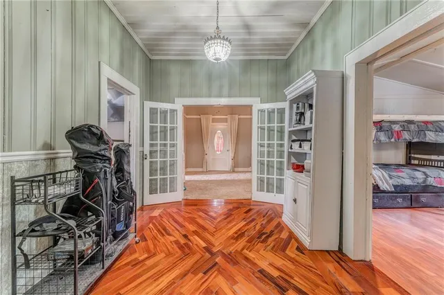 a room with a bed and a book shelf
