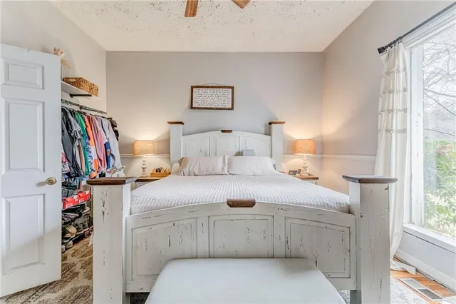 a bedroom with furniture and a flat screen tv