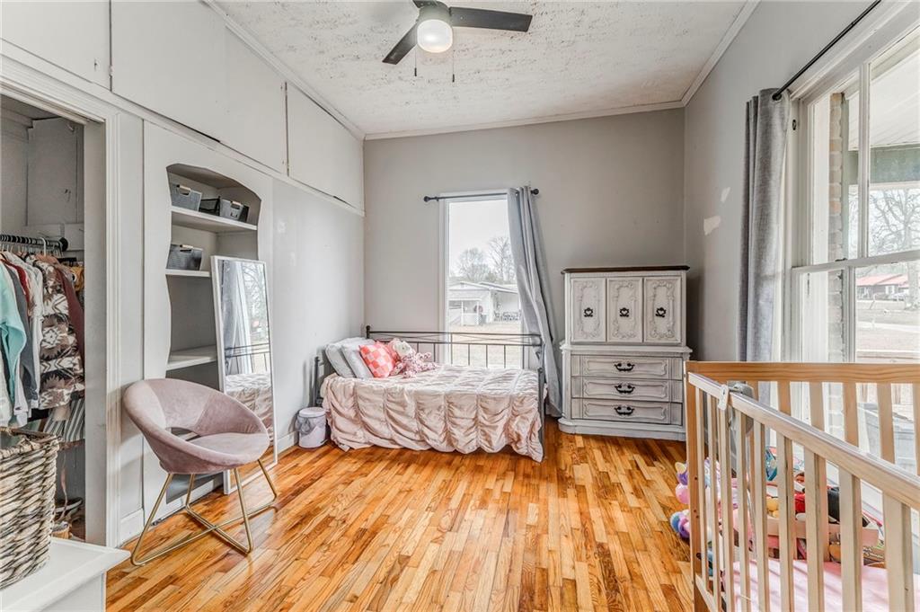455 River Bend Road Southwest Plainville, GA 30733 - Photo 32 of 59 a bedroom with furniture and a wooden floor