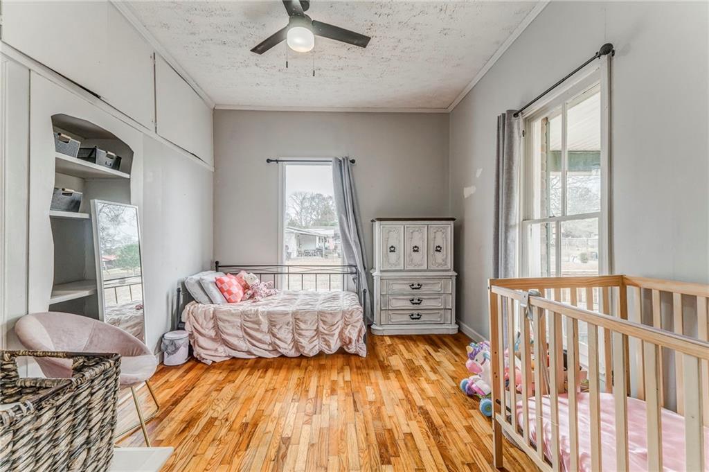 455 River Bend Road Southwest Plainville, GA 30733 - Photo 33 of 59 a bedroom with a bed and wooden floor