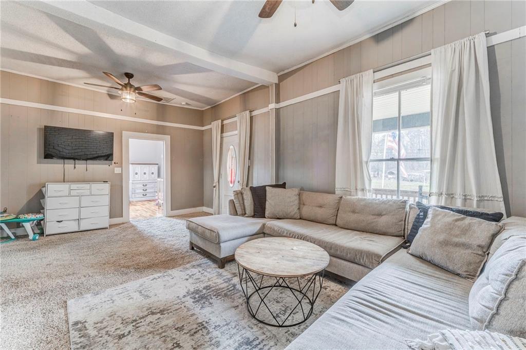 455 River Bend Road Southwest Plainville, GA 30733 - Photo 38 of 59 a living room with furniture a flat screen tv and a window