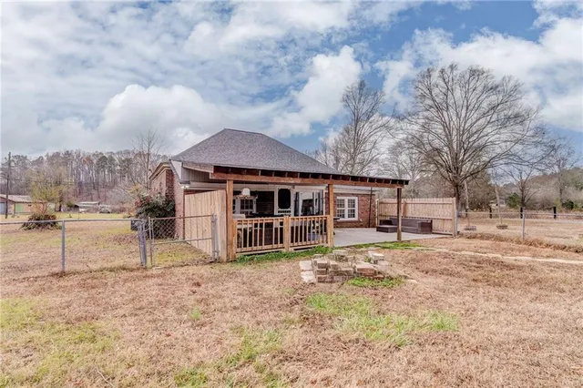 a view of a house with a yard covered in snow