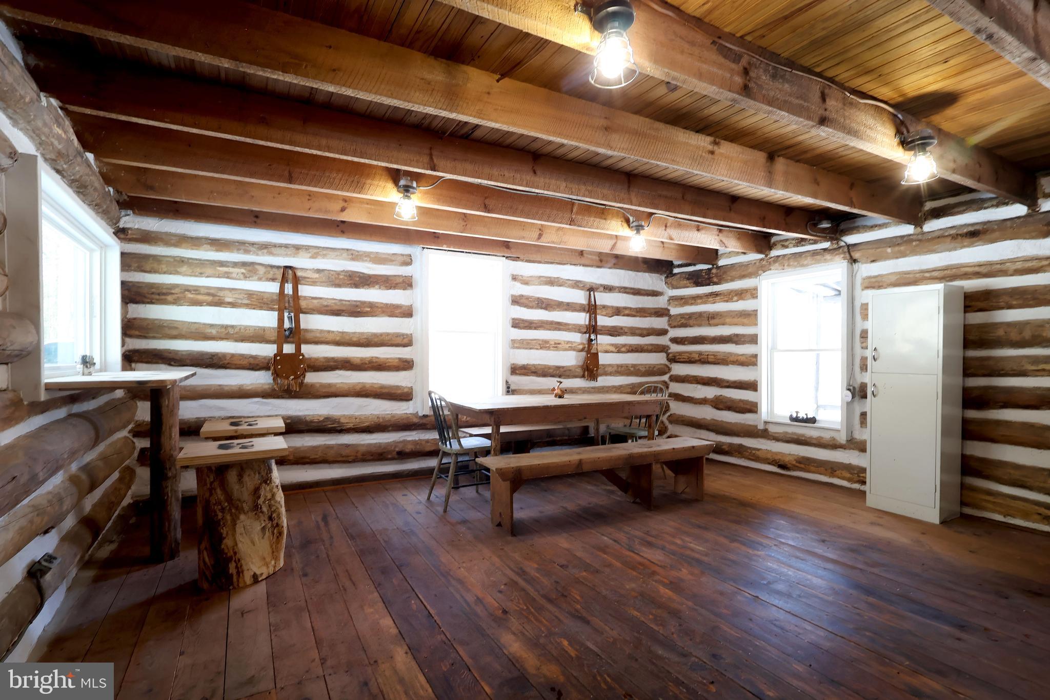 4464 Tram Road Spruce Creek, PA 16683 - Photo 11 of 53 a view of a room with wooden floor and windows