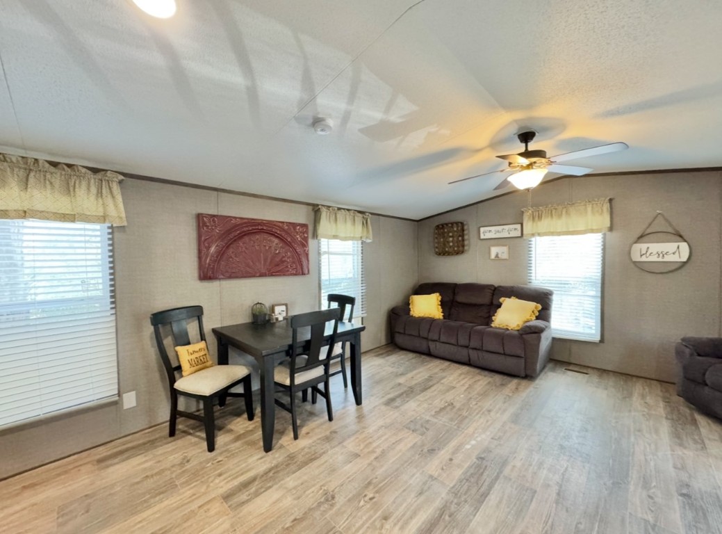 1575 County Rd B Lexington, TX 78947 - Photo 13 of 35 a living room with furniture and a wooden floor