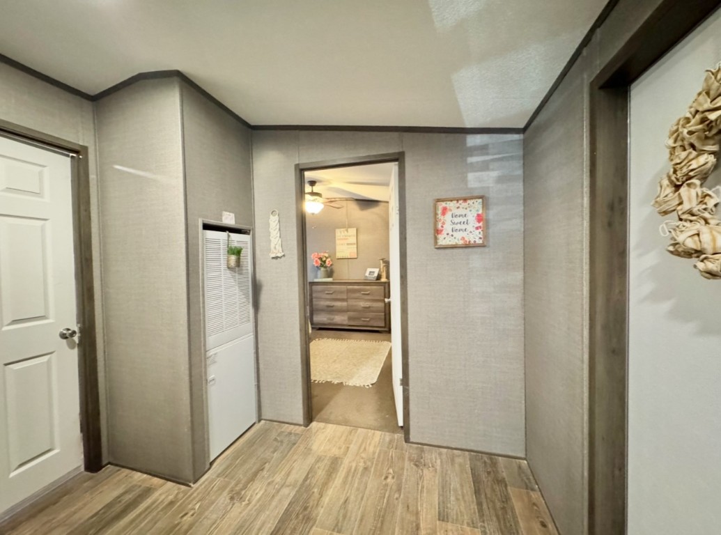 1575 County Rd B Lexington, TX 78947 - Photo 16 of 35 a view of a hallway with wooden floor and a bathroom