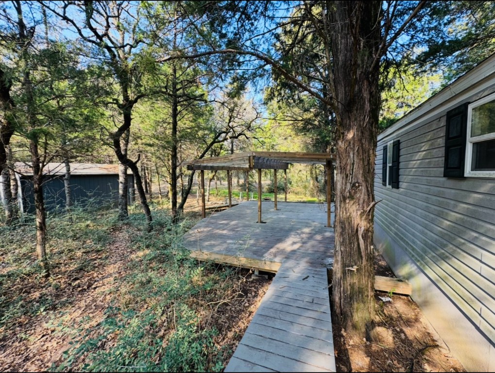 1575 County Rd B Lexington, TX 78947 - Photo 2 of 35 a view of a yard with wooden fence and large trees