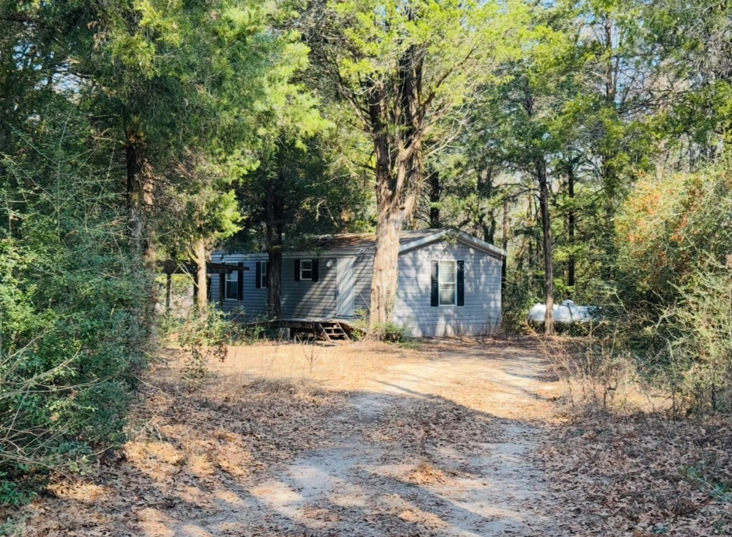 1575 County Rd B Lexington, TX 78947 - Photo 33 of 35 a view of a house with a yard