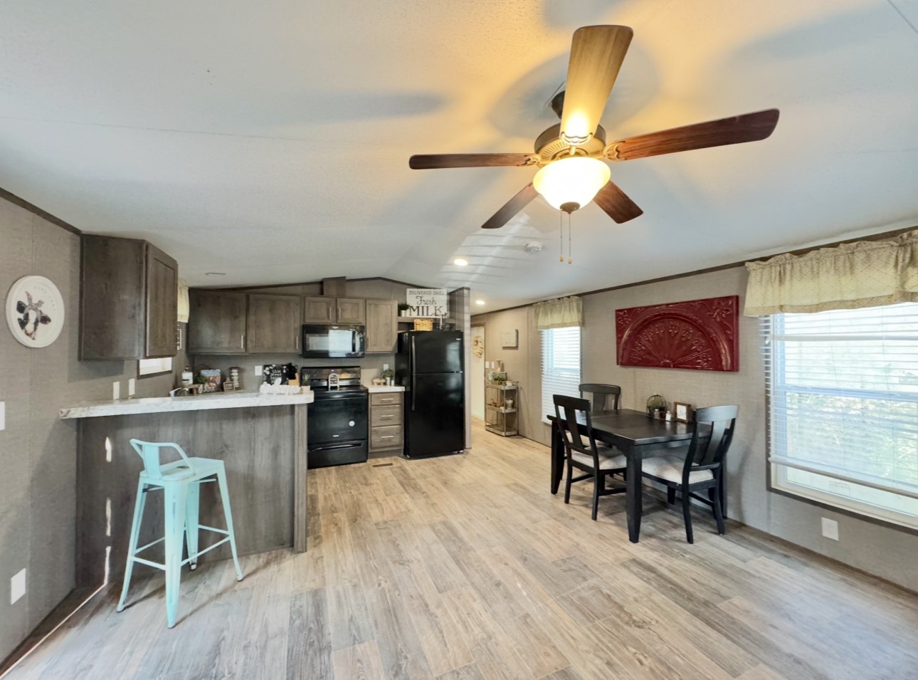 1575 County Rd B Lexington, TX 78947 - Photo 7 of 35 a kitchen with stainless steel appliances granite countertop a stove top oven a dining table and chairs with wooden floor