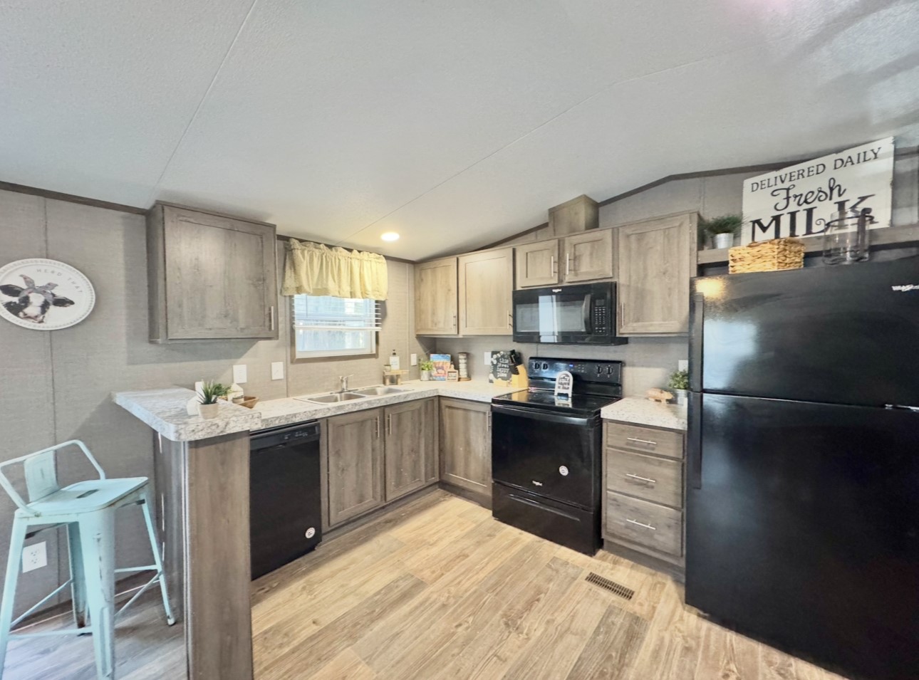 1575 County Rd B Lexington, TX 78947 - Photo 10 of 35 a kitchen with granite countertop a sink stove and refrigerator