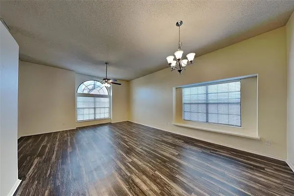 a view of a livingroom with wooden floor and a window