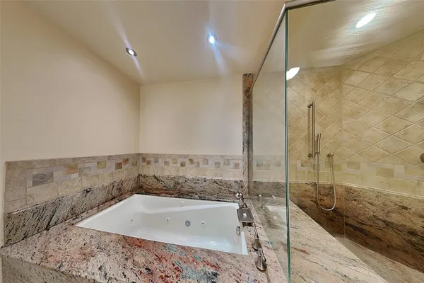 a bathroom with a bathtub and a sink