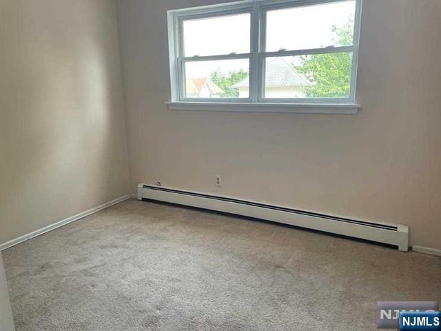 435 Teaneck Road, Unit 19 Ridgefield Park, NJ 07660 - Photo 5 of 7 an empty room with a window