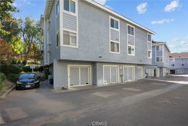 a couple of cars parked in front of a building