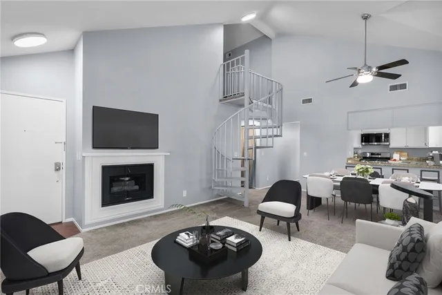a living room with furniture a fireplace and a chandelier