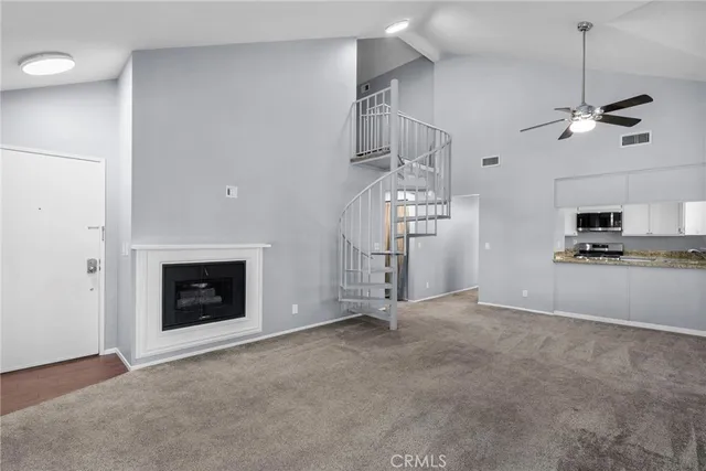 a view of empty room with cabinet and fireplace