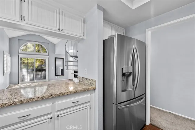 a kitchen with stainless steel appliances granite countertop a refrigerator and a sink