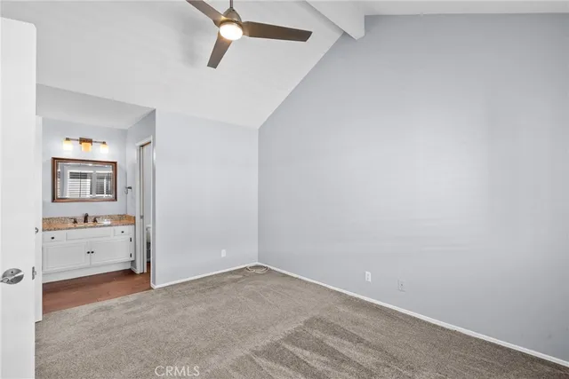 an empty room with a cabinet and mirrors