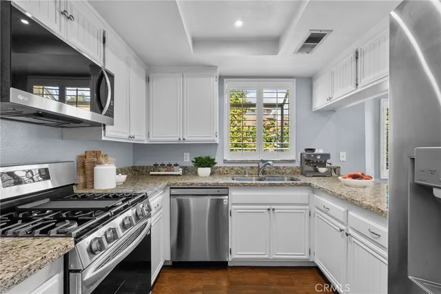 a kitchen with a stove a sink and a microwave