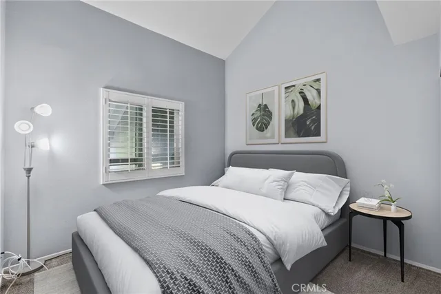 a bedroom with a bed and a painting on the wall