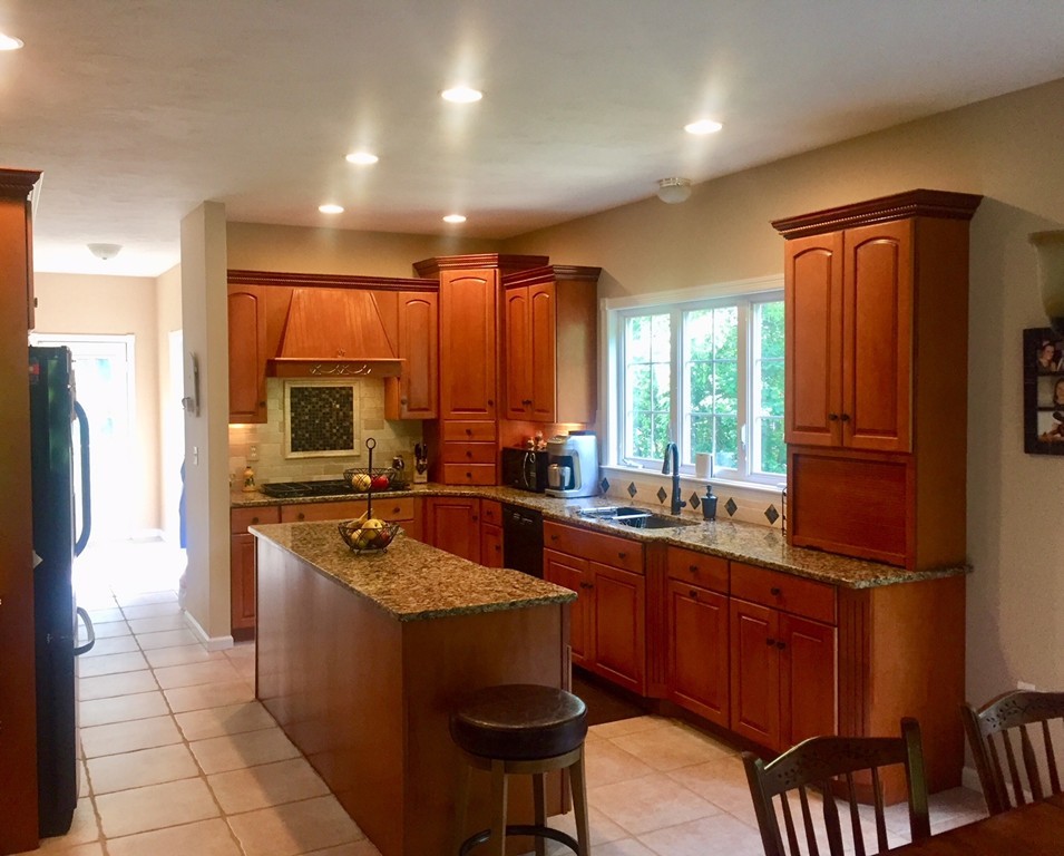 20 Broken Tree Road Medway, MA 02053 - Photo 6 of 8 a kitchen with stainless steel appliances granite countertop a sink a stove a refrigerator a washer and dryer