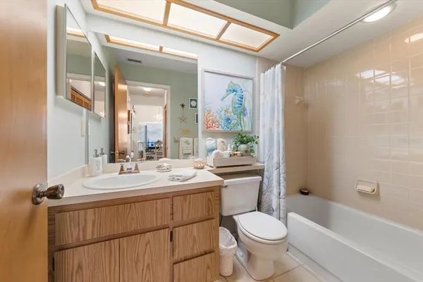a bathroom with a double vanity sink toilet and shower