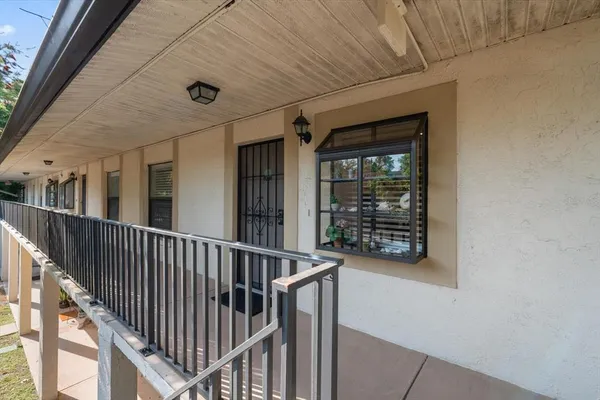a view of staircase with white walls and windows