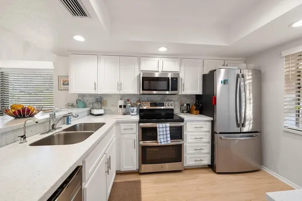 a kitchen with a refrigerator sink and microwave