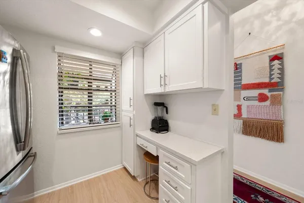 a kitchen with stainless steel appliances cabinets and a window