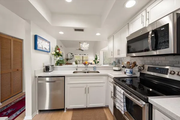 a kitchen with a sink stove and microwave