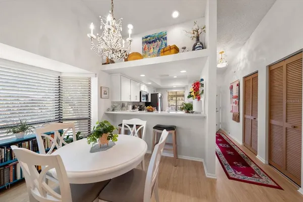 a view of a dining room with furniture and a chandelier