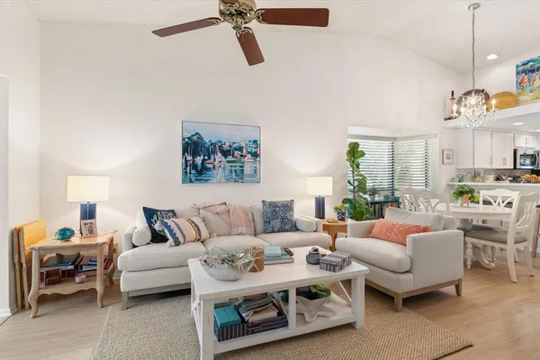 a living room with furniture and a chandelier