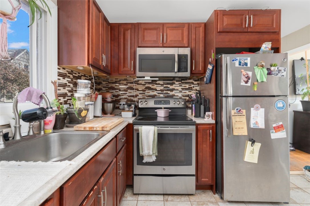 8 A Street Westerly, RI 02891 - Photo 17 of 24 8 A Right Unit Kitchen
Stainless Appliances, Tile Backsplash. This refrigerator belongs to the tenant