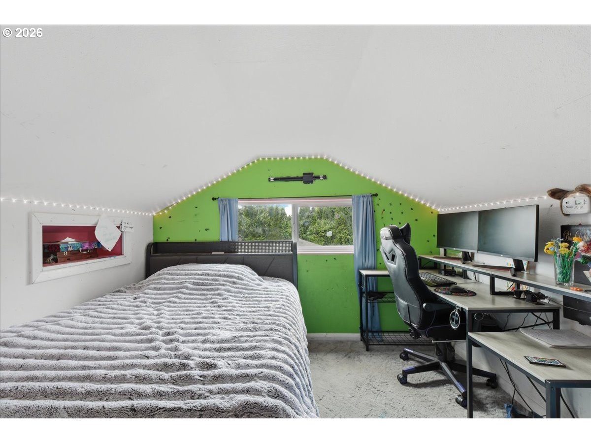 3287 Olive Way Longview, WA 98632 - Photo 15 of 24 a bedroom with a bed and a desk