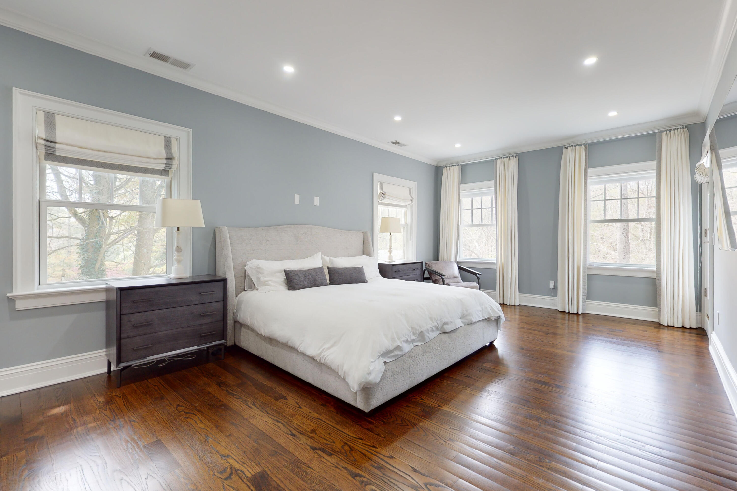 18 Cat Rock Road Cos Cob, CT 06807 - Photo 17 of 37 a spacious bedroom with a large bed and wooden floor
