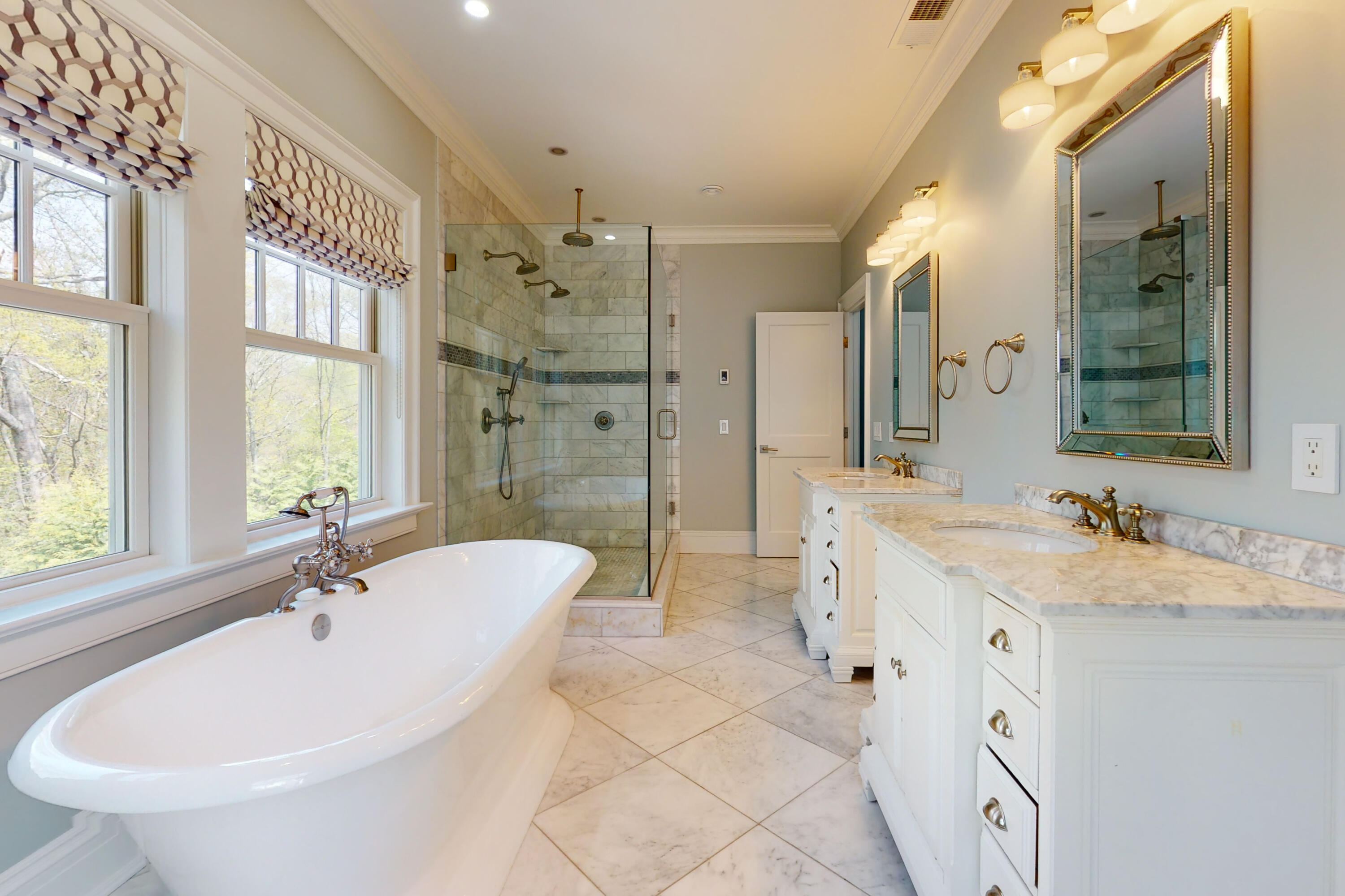 18 Cat Rock Road Cos Cob, CT 06807 - Photo 19 of 37 a spacious bathroom with a bathtub shower sink and mirror