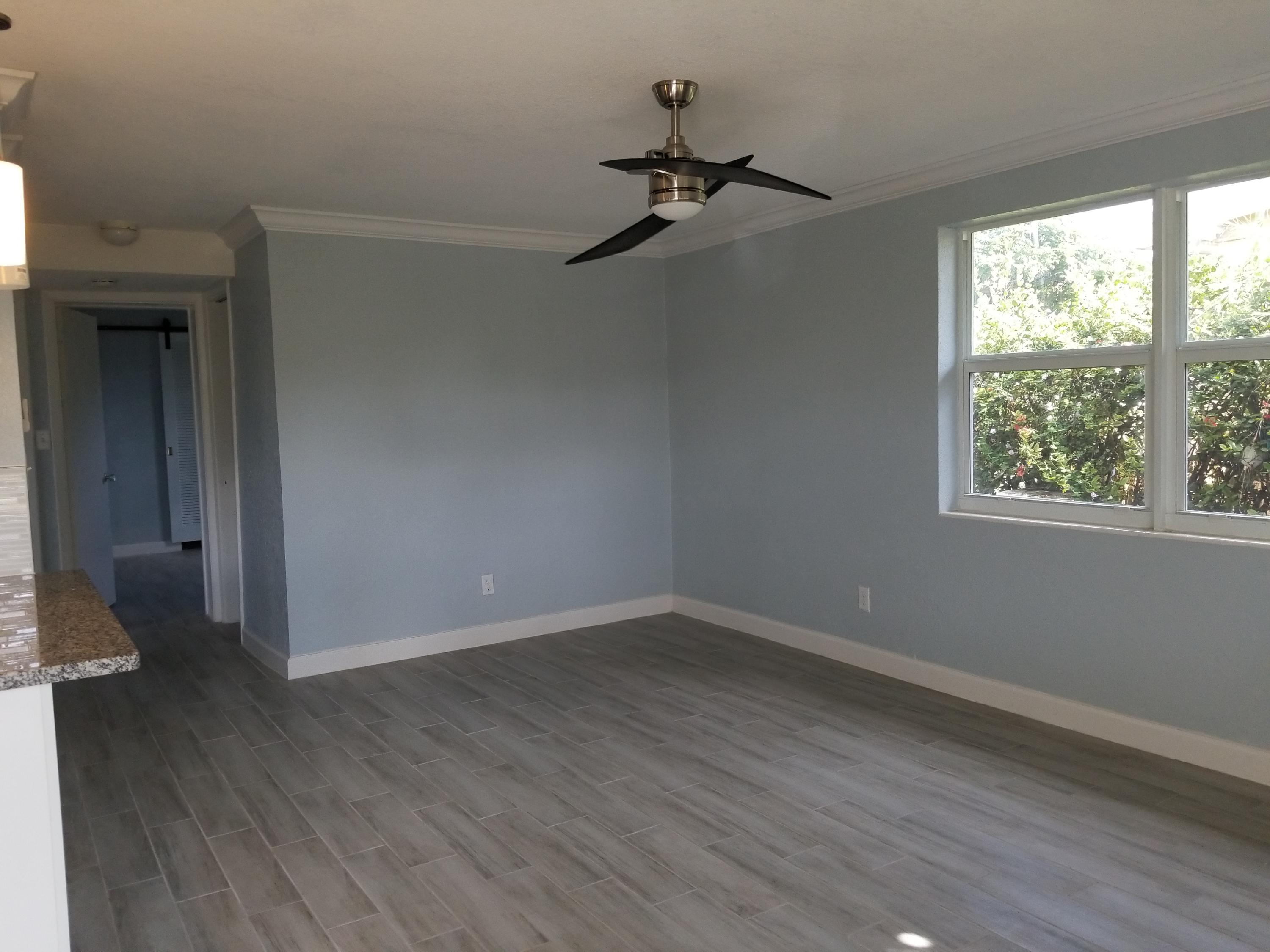 1221 Highview Road Lake Worth, FL 33462 - Photo 4 of 20 a view of a room with wooden floor closet and windows