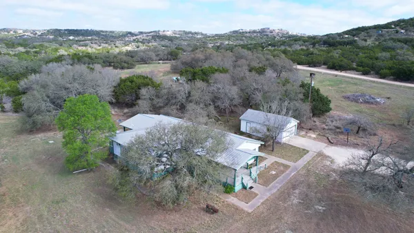 an aerial view of a house with a yard