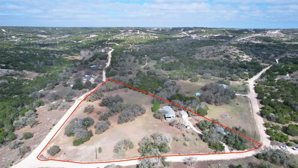 an aerial view of a house with a yard