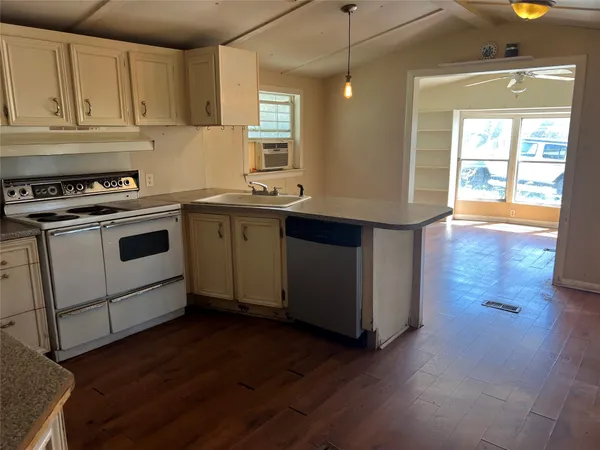 a kitchen with a stove and a sink