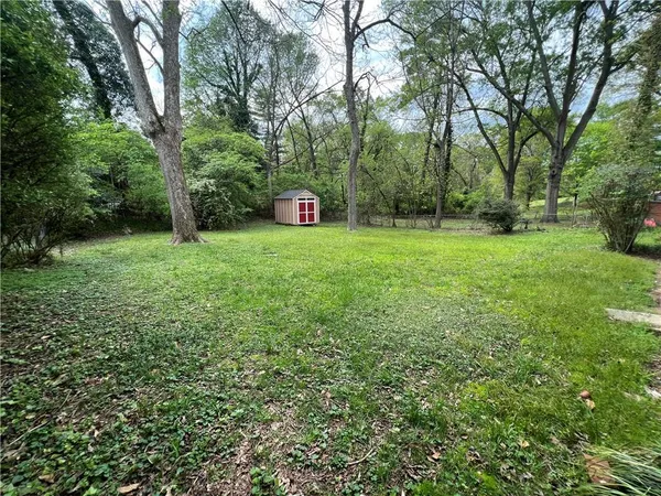 a view of a backyard with large trees