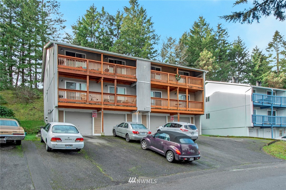 3941 Mason Loop Road Tacoma, WA 98409 - Photo 1 of 16 a car parked in front of a house