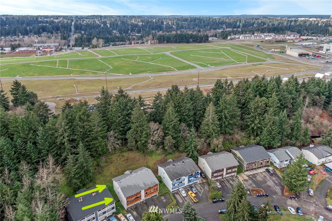 3941 Mason Loop Road Tacoma, WA 98409 - Photo 16 of 16 a view of a golf course with a lake
