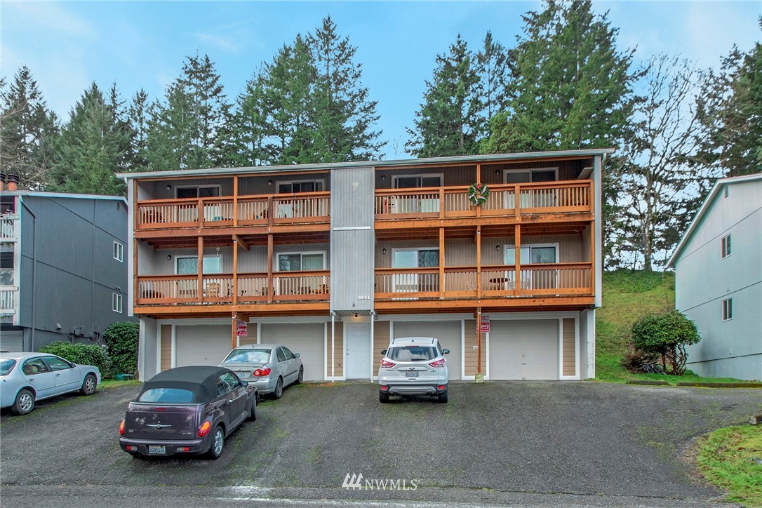 3941 Mason Loop Road Tacoma, WA 98409 - Photo 7 of 16 a car parked in front of a building