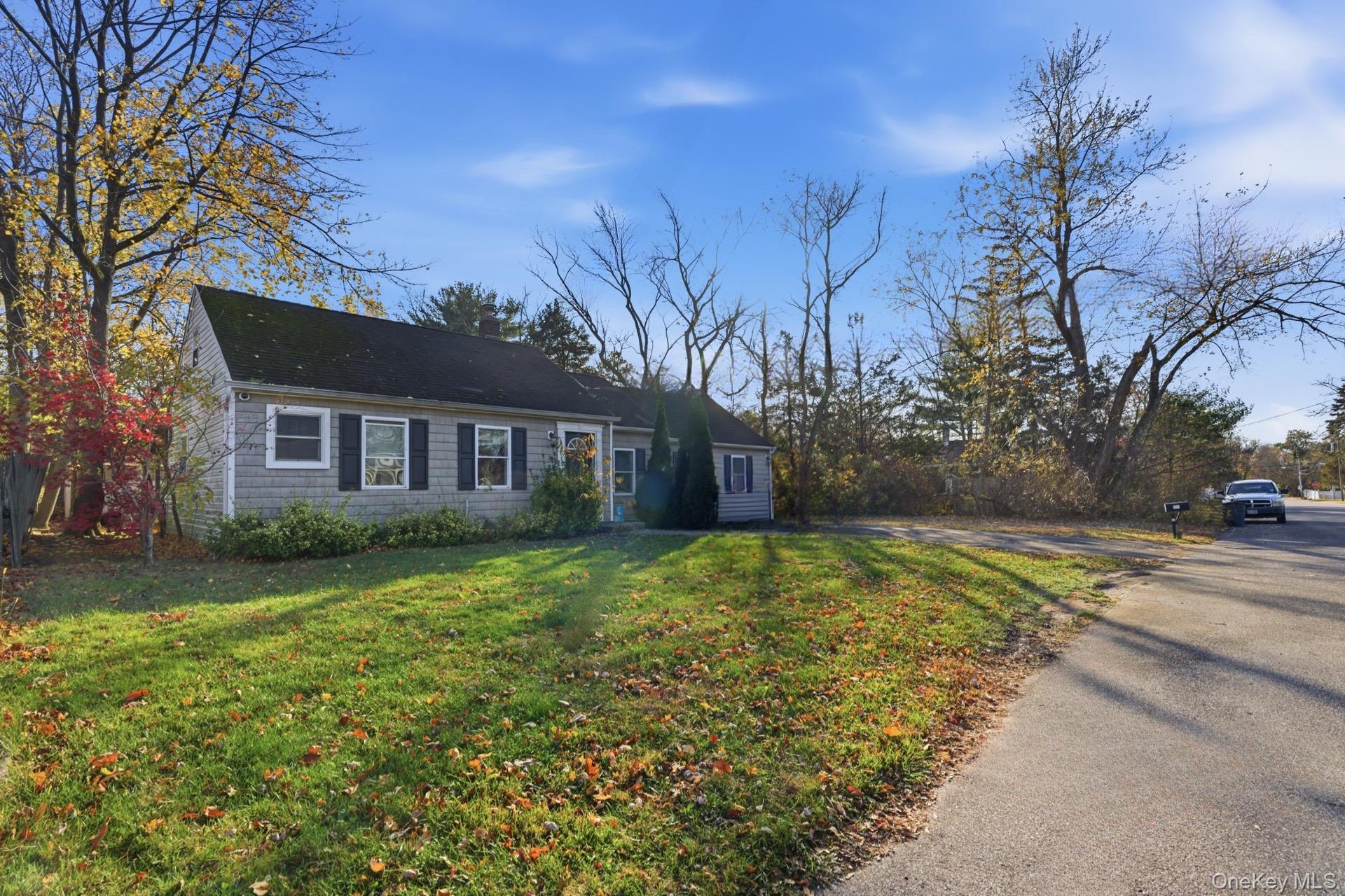 36 Ralph Avenue Brentwood, NY 11717 - Photo 2 of 25 a front view of a house with a yard