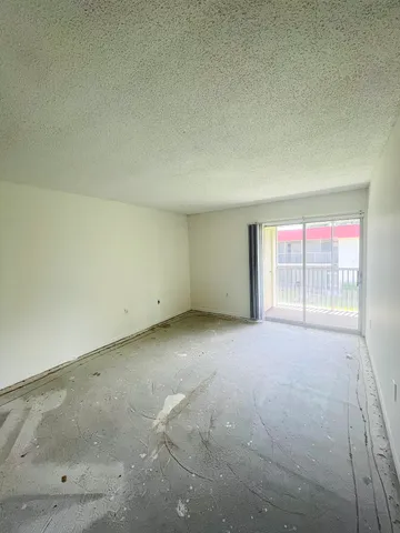 a view of an empty room with a window