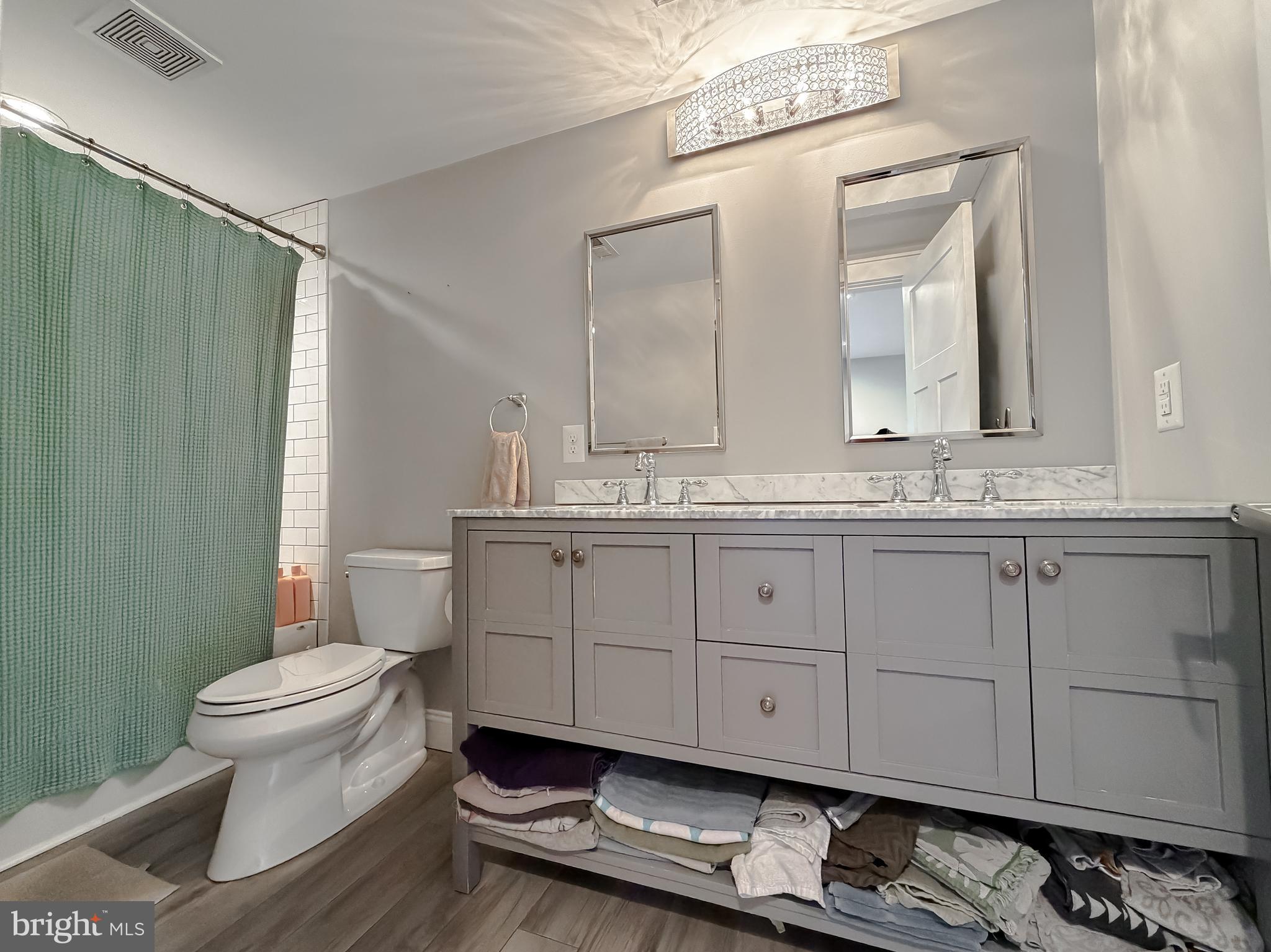 16146 Thomas Road Piney Point, MD 20674 - Photo 30 of 57 a bathroom with a granite countertop sink and a toilet