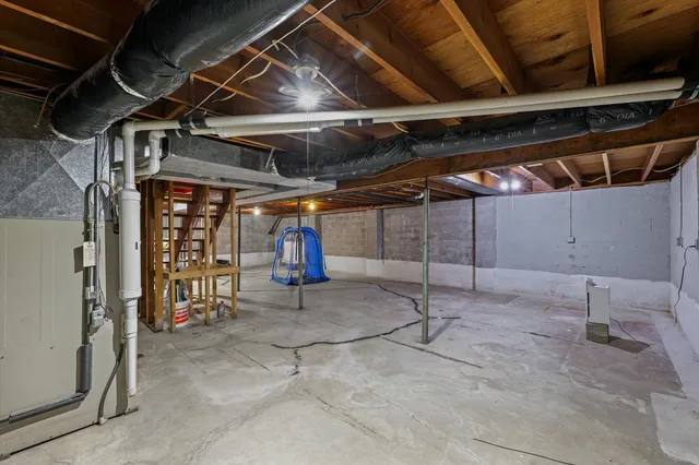 a front view of house with a garden and trees