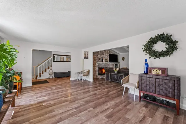 a living room with furniture a window and a flat screen tv