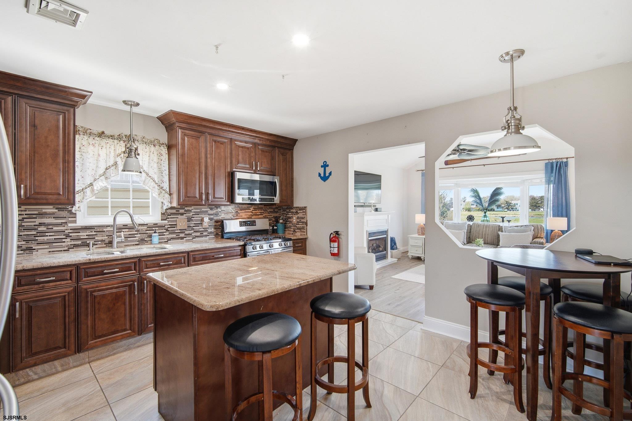 214 Hagen Road Brigantine, NJ 08203 - Photo 12 of 34 a kitchen with granite countertop a stove and a center island