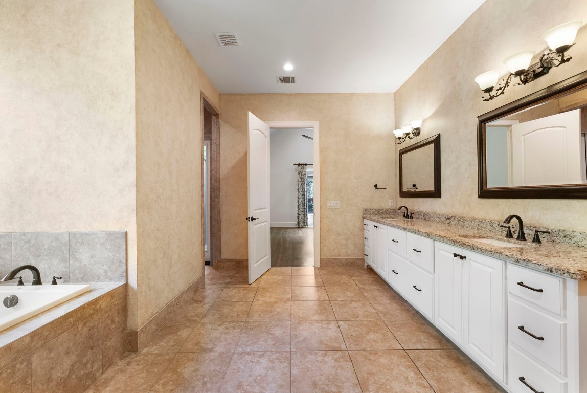 3810 Oreana Court Spring, TX 77386 - Photo 13 of 44 a spacious bathroom with a granite countertop sink mirror and bathtub